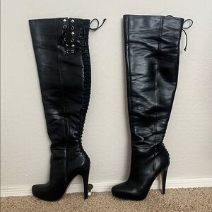 Knee length leather heeled boots.